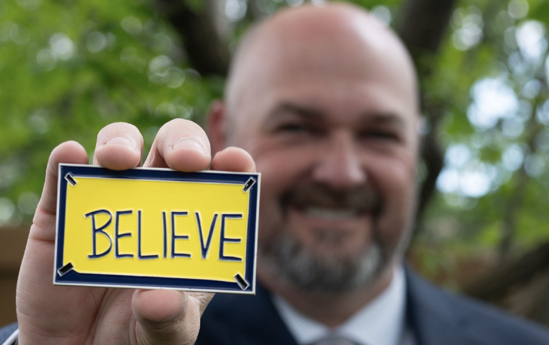 organizational development expert Matt Davis with a yellow card representing his "BELIEVE" framework